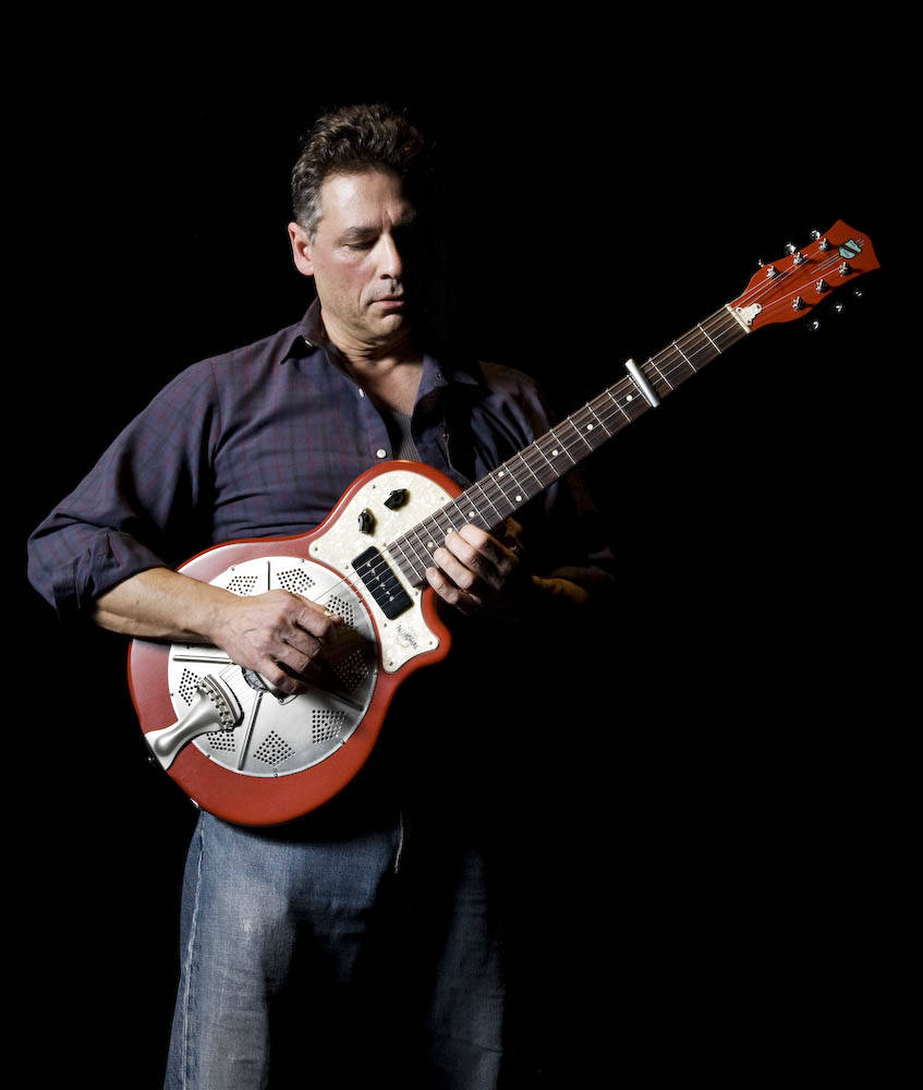 Dean Santomieri playing guitar